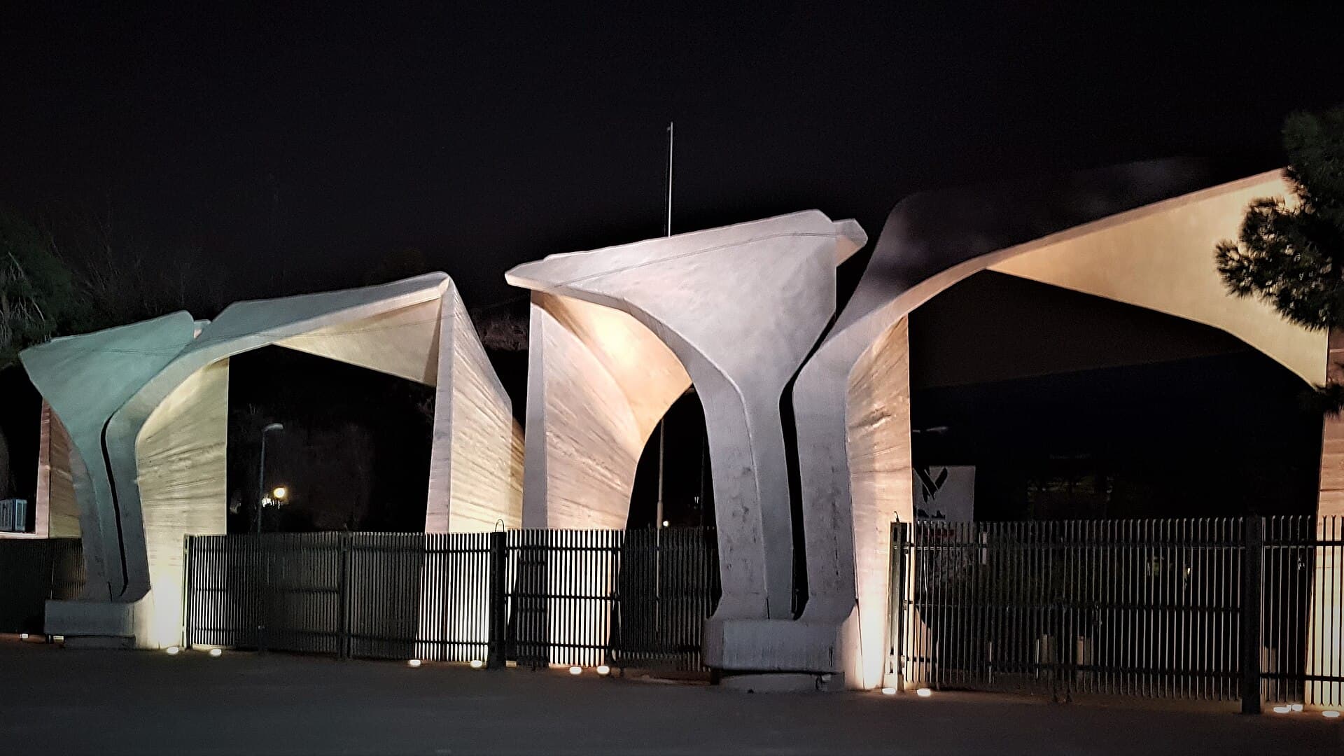 The main entrance gate of the University of Tehran at night