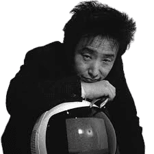 A black-and-white portrait of a man with messy, spiked hair, leaning thoughtfully on a retro-styled television set. Dressed in a dark suit, his pensive expression and the vintage TV screen, which displays a faint image, create a blend of modernity and nostalgia. The minimalist background draws attention to the unique combination of the man's creative personality and the old technology.