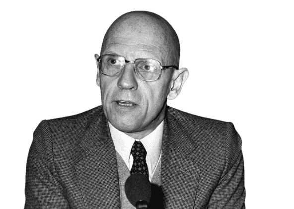 A black-and-white photograph of Michel Foucault, the influential French philosopher and social theorist. Wearing glasses and a formal suit, Foucault is seen speaking into a microphone, reflecting his role as a public intellectual. Known for his critical studies of power, knowledge, and institutions, Foucault's works, such as "Discipline and Punish" and "The History of Sexuality," reshaped the fields of philosophy, sociology, and political theory. This image captures his intellectual rigor and his impact on contemporary thought, particularly his analysis of societal structures and power dynamics.