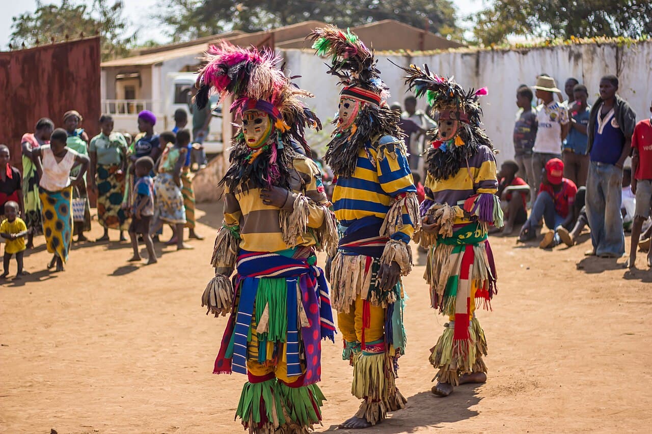 A masked and costumed Gule Wamkulu dancer