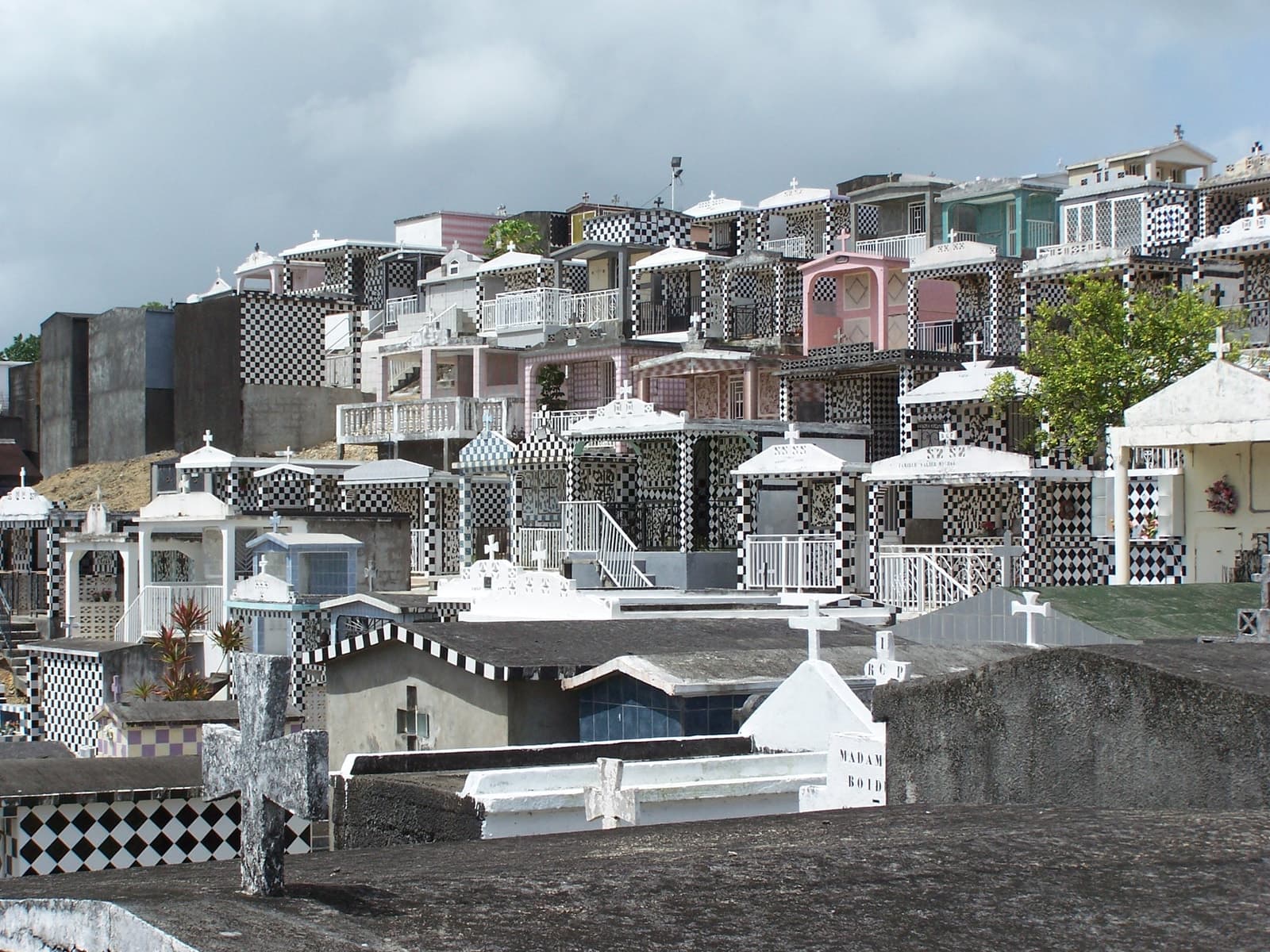 The cemetery at Morne-à-l'Eau in Guadeloupe, its above-ground family tombs faced in black-and-white checkerboard tiles and stacked in terraces up the hillside